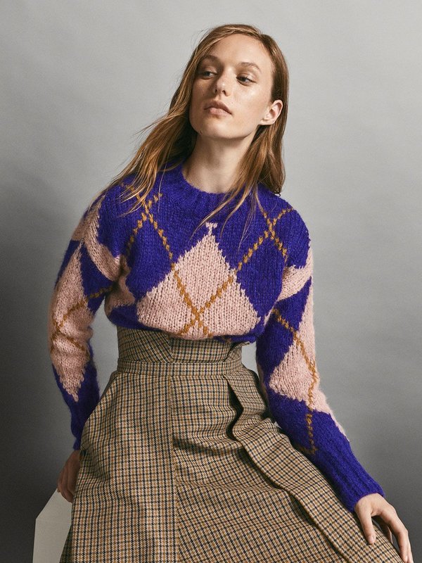 Fille dans un pull en diamant avec une jupe Fille dans un pull en diamant avec une jupe